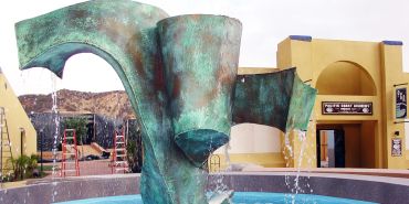 Modern abstract water fountain with green patina.