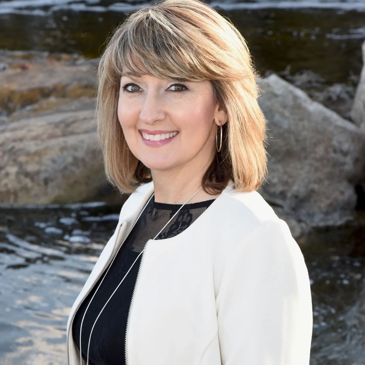 Photo of Susan Reynolds Realtor in Arizona smiling by a body of water.