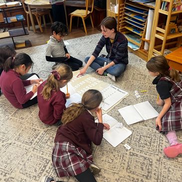 A lady teaching a group of children in a room