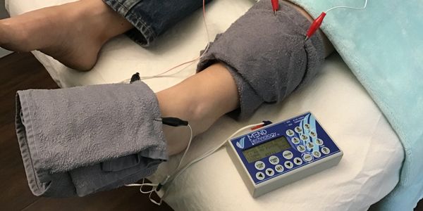 Frequency Specific Microcurrent: therapy laying down with towels and electrodes.