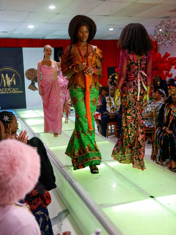 Models showcasing vibrant African-inspired fashion on a runway.