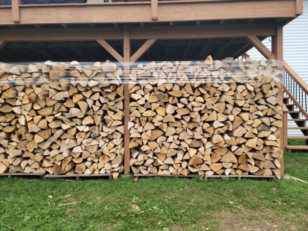 Two cords of split, seasoned hardwood stacked and ready for delivery