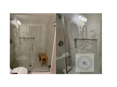 Modern bathroom shower with glass door and tiled walls.