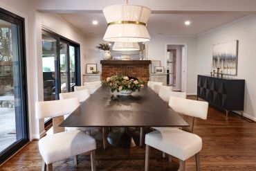 Elegant dining room with a wooden table and cream chairs.