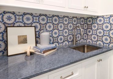 Kitchen countertop with decorative tile backsplash.