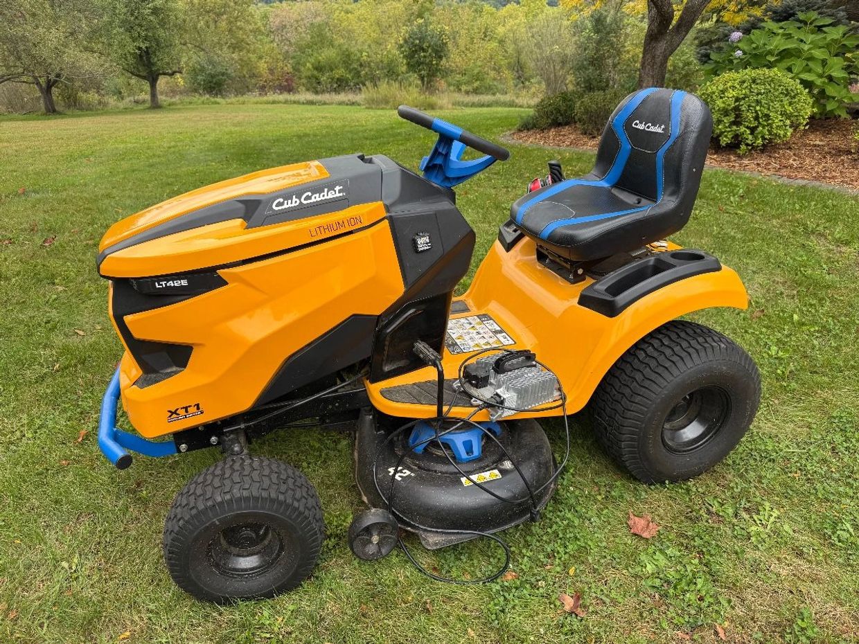 Orange Cub Cadet lawn mower on grass.