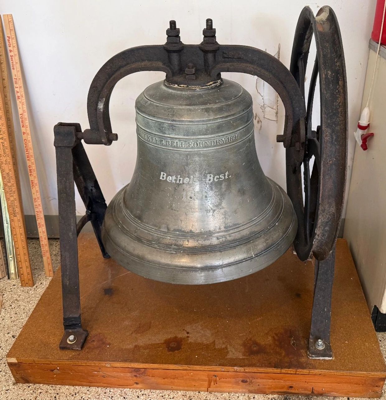Antique bell with stand and wheel.