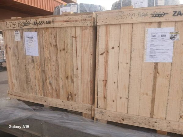 Two large wooden crates with shipping labels.