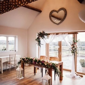 Wooden backdrop with chiffon drapery and faux florals