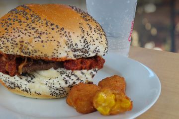 Burger topped with chili and cheese for a chili cheese sloppy joe