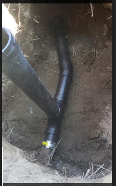 Underground pipe connection in a dug hole.