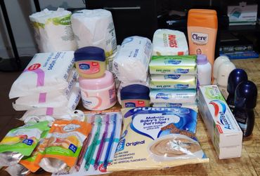 A collection of personal care and hygiene products arranged on a table.
