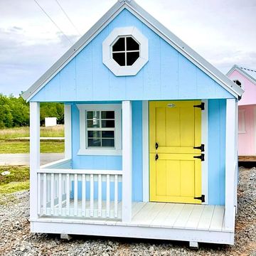 Small playhouse painted blue with a bright yellow door and white trim.
