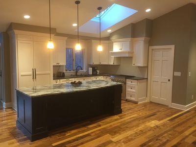 Kitchen with black island and skylight