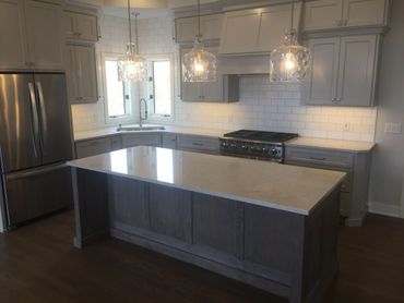 gray painted kitchen with white oak center island
