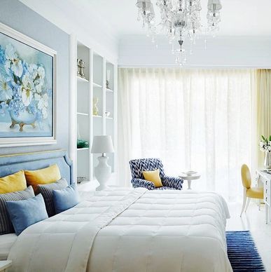 Bright and elegant bedroom with white bedding and colorful accents.