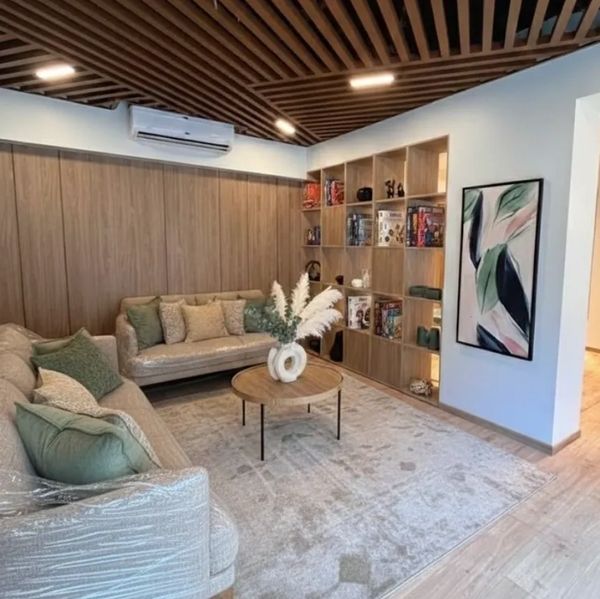 Cozy living room with neutral tones, wooden accents, and modern decor.