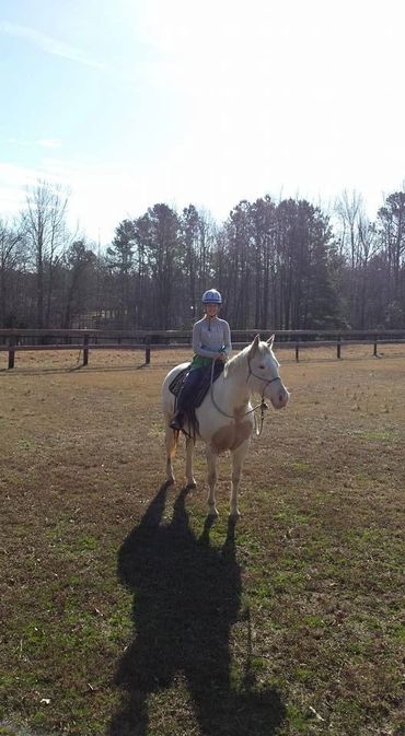 A young girl with a lesson horse