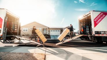 Two Bend Brothers Moving Trucks with movers efficiently unloading boxes during a Bend Or Move 