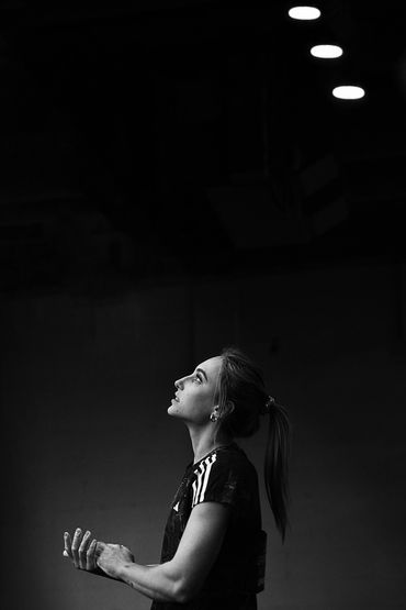 Black and white portrait of a woman looking upward thoughtfully.