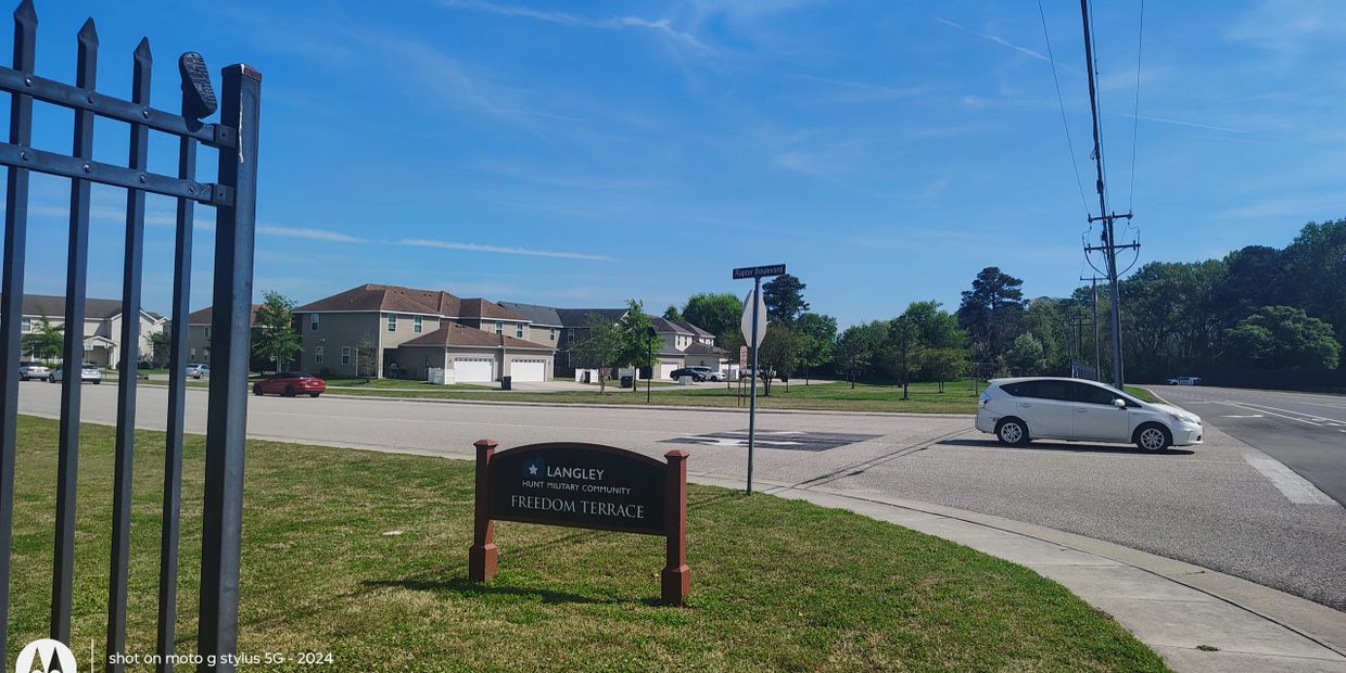 Sign for Langley Hunt Military Community Freedom Terrace in a suburban area.
