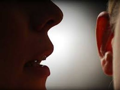 some whispering pcs secrets into a persons ear in Hampton VA from Veterans Moving Company.
