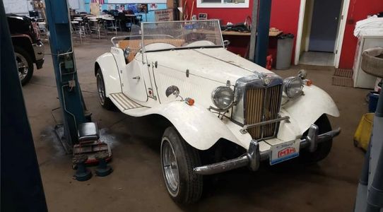 A roadster in the auto shop.