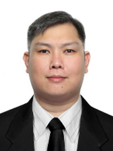Professional headshot of a man in a suit and tie against a white background.