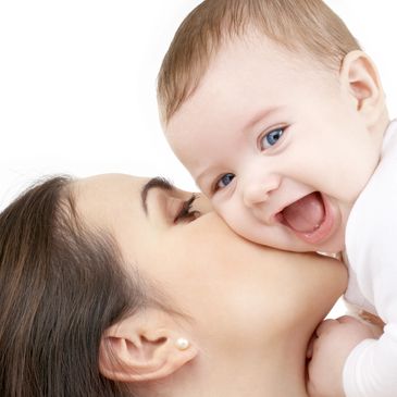 Happy mum holding a happy baby who has been breastfeeding successfully