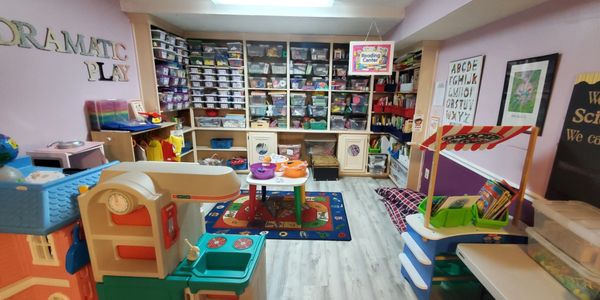 Colorful and organized children's playroom with labeled bins and learning stations.