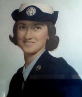 Portrait of a woman in a navy uniform and hat.