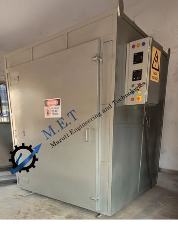 Industrial electrical oven with safety warnings and control panel.