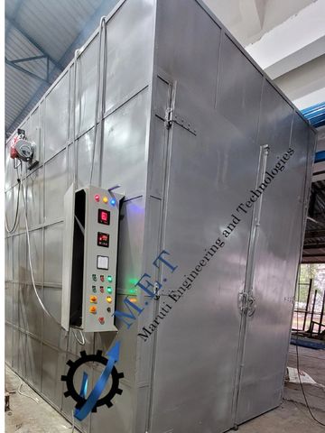 Large industrial stainless steel equipment with control panel.