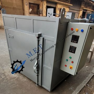 Industrial oven with control panel in a factory setting.