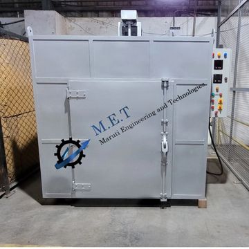 Industrial oven with control panel in a workshop.