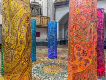 Colorful decorated pillars inside a historic building.