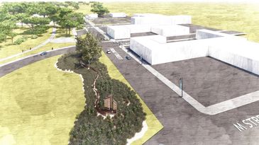 Aerial view of a modern campus with white buildings and green landscaping.