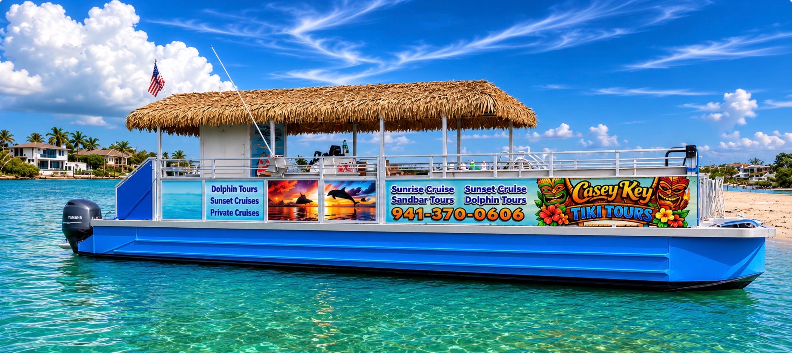 Tiki tour boat on clear blue water near a sandy beach.