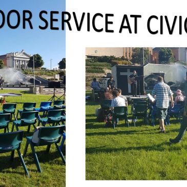 Outdoor civic park service with chairs and attendees.