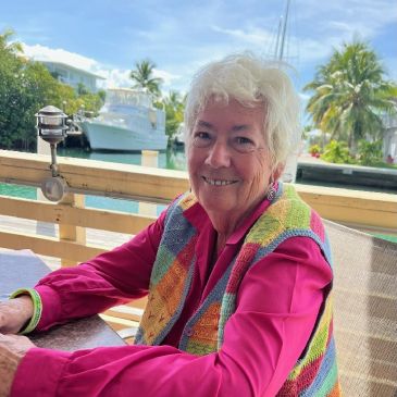 Smiling elderly woman at a marina.