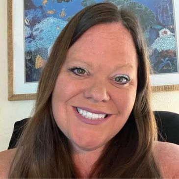 Smiling woman with long brown hair.