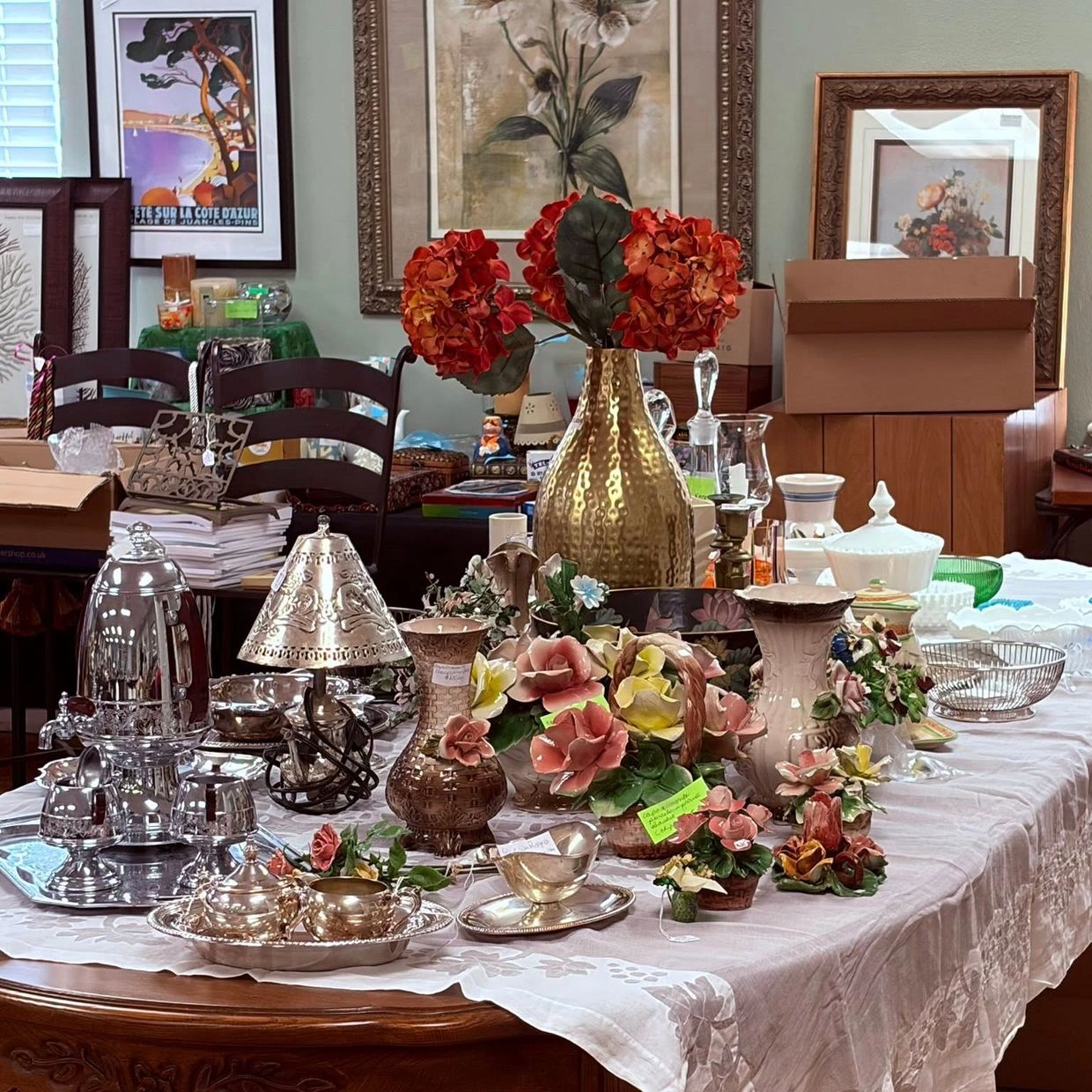Table with various decorative items and vases.