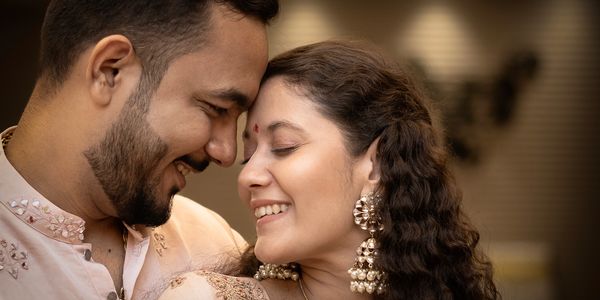 a Couple in elegant attire embracing under a chandelier. Couple photography, couple love, prewedding