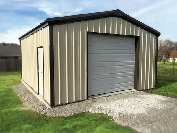 New metal garage with beige walls and a white roll-up door.