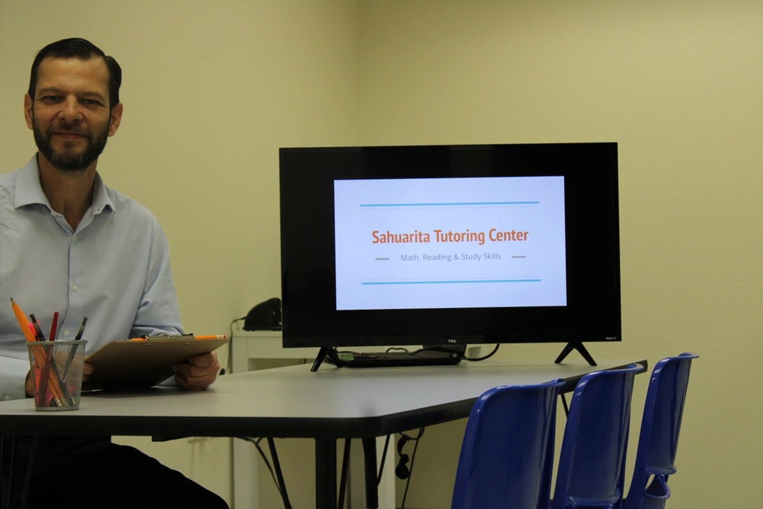 Tutor at Sahuarita Tutoring Center with monitor displaying math, reading and study skills.