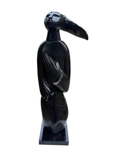 Abstract black sculpture of a figure with elongated features.