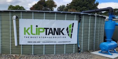 A large Kliptank storage tank with a company banner.