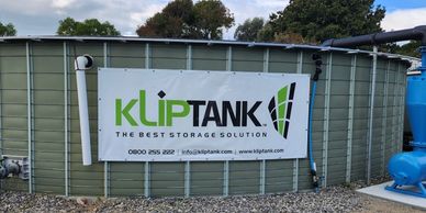 A large Kliptank storage tank with a company banner.