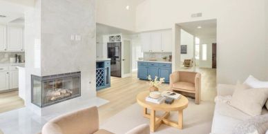 Bright living room with modern fireplace and pastel furniture.