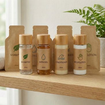 Eco-friendly travel toiletries set with shampoo, bath gel, conditioner, and body lotion.